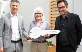 Architekt Peter Hilgarth (r.) überreichte an HPZ-Vorstandsvorsitzenden Christian Stadler (l.) und an stellvertretende Aufsichtsratsvorsitzende Daisy Brenner (Mitte) nicht nur offiziell den Schlüssel für das Kinder- und Jugendwohnen „Am Kleefeld“, sondern auch einen Spendenscheck über 2500 Euro.