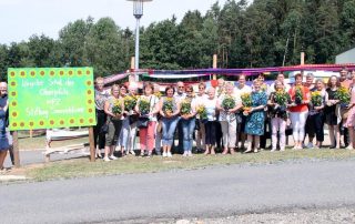 Rund 80 Helferinnen und Helfer, hier die Vertreterinnen der Strickrunden, Vereine und Verbände mit den HPZ-Verantwortlichen, sorgten am Donnerstagmittag dafür, dass das Kinder- und Jugendwohnen „Am Kleefeld“ im Heilpädagogischen Zentrum (HPZ) Irchenrieth mit dem definitiv längsten Schal der Oberpfalz eingewickelt wurde.
